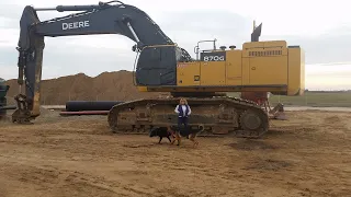 Diging with an John Deere 870G Excavator.