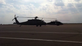 Two UH-60M Blackhawk helicopters start and takeoff from Salina