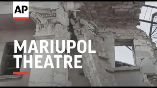 Workers sort debris at destroyed Mariupol theatre