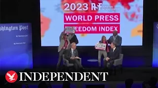 Protester confronts Antony Blinken on stage in support of Julian Assange