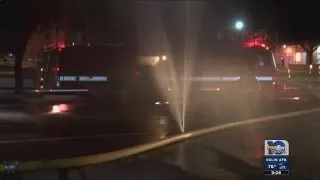 Car runs over, bursts fire hose during fire