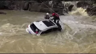 Hero firefighters rescue woman trapped in flooded car