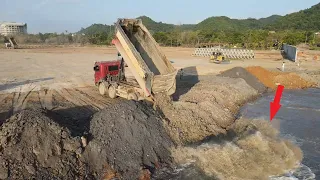Awesome Construction Machinery Operator Dump Truck Drop Down Rock And Soil To The Sea Water