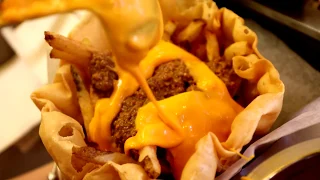 French Fries in a Taco Salad Bowl, Topped with Meat & Smothered in Cheese