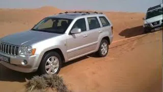 2008 Jeep Grand Cherokee Overland Edition recovers Nissan Xterra from sand