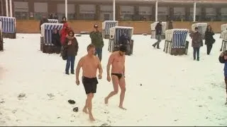 It's freezing! Brave swimmers take plunge in ice cold lake in Berlin