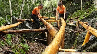 The process of building a wooden bridge across a stream. Ensure safety before the rainy season