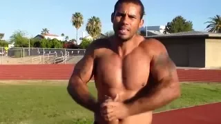 bodybuilder flexing biceps - Muscle God Samson