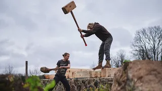 Assembly of Northmen wooden house. Timber frame raising