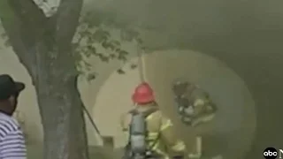 Heroic firefighter catches baby thrown from burning building