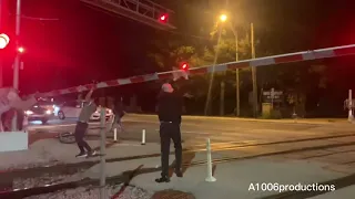 Truck hits a train crossing gate while a Metra stops by.