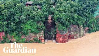 China floods: footage shows Giant Buddha statue before and after torrential rainfall