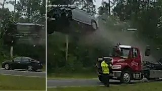 Car flies airborne off back of tow truck in shocking Georgia crash, driver survives