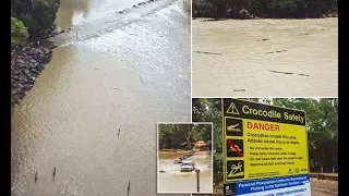 4WD crosses Cahill's Crossing surrounded by crocodiles 