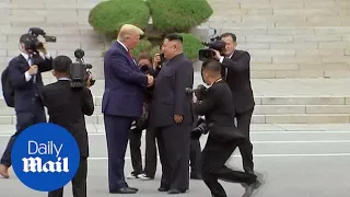 Moment Trump steps into North Korea to meet Kim Jong-un