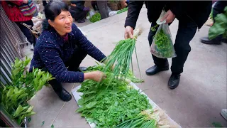 Primitive lifestyle - Chinese farmer selling veggies on the village market