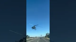 Twin Ukraine Mi-8/17 helicopters fly low over a civilian highway