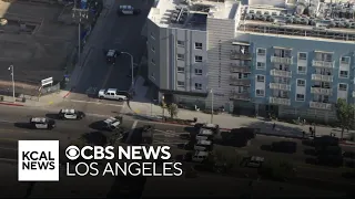 Possibly armed shooting suspect barricaded inside of South LA apartment building