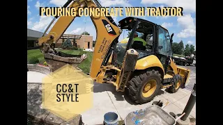 Pouring concrete with tractor