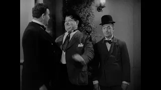 Laurel and Hardy get past an aggressive doorman in Hollywood party 1938.