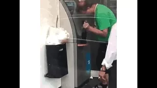 Guy drops a beer bottle while using the atm