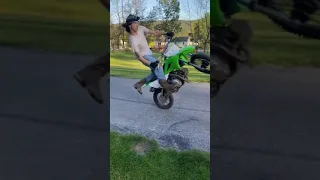 Kid wrecks his dirt bike doing a wheelie