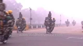 Indian soldiers rehearse bike stunts on a foggy morning, for Republic Day