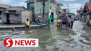 Elevated motorbike taxis help Philippine town navigate persistent floods