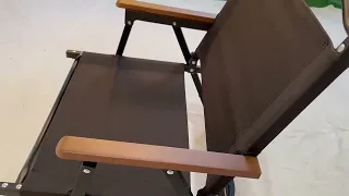 Folding portable chair with wood armrest.