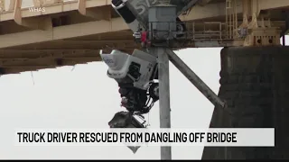 Truck driver rescued from dangling off bridge