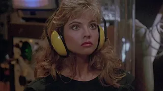 Karen Mistal wears yellow ear defenders in Return of the Killer Tomatoes (1)