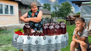 Life elderly couple in the Carpathian valley. Grandma preserves compote for the winter