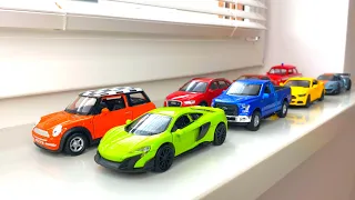 Diecast Cars Moving By Hand On The Windowsill. Diecast model cars from the box