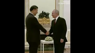 Putin warmly shaking hands with China's Xi when meeting in Moscow, Russia