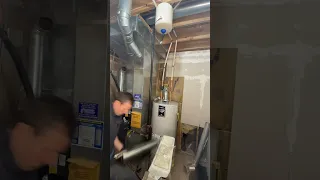 Replacing the vent connector during a water heater replacement.