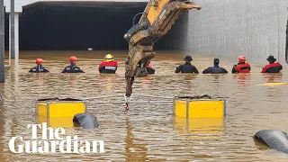 Rescuers try to reach people stuck in flooded tunnel in South Korea