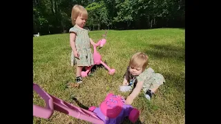 Twins play with bubble mower