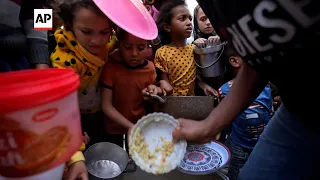 With famine looming, charity workers in Gaza distribute food to crowds of children