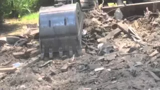 Excavator loading dumpster
