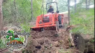 Kubota L2501 clearing land and pulling trees out