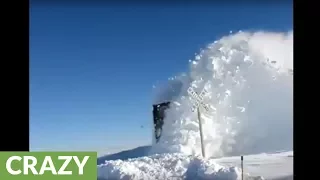 Train plows through heavy snow, results in stunning footage