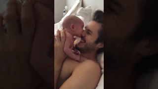 Newborn baby suckling dads nose