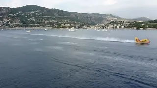 Water Bombers load up next to cruise liner Amazing pilot skill in action
