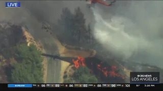 Helicopters extinguishing fire with water drops