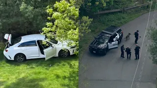 Car ditched in backyard after armed robbery; 1 suspect at large