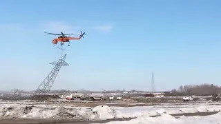 Helicopter picking up power line tower HD