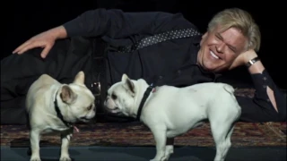 Ron White plays with his dogs on stage