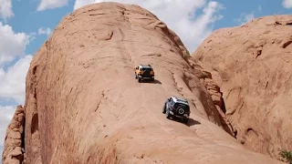 Jeeps climbing a vertical Mountain