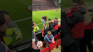 Young boy at Anfield enters the pitch, steals a ball and runs away.