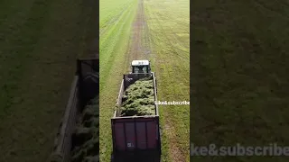 John Deere 7710 pulling a load of grass